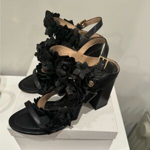 Tory Burch black heels with floral detail.